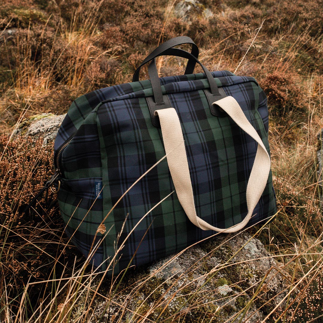 View 3/4 of missak aviator bag in tall grass