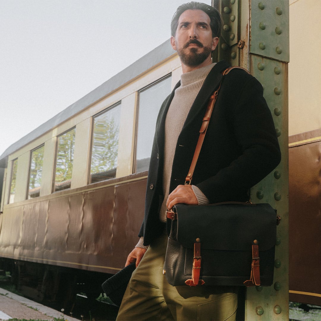 Men's jean's jacket worn by a man in front of a train