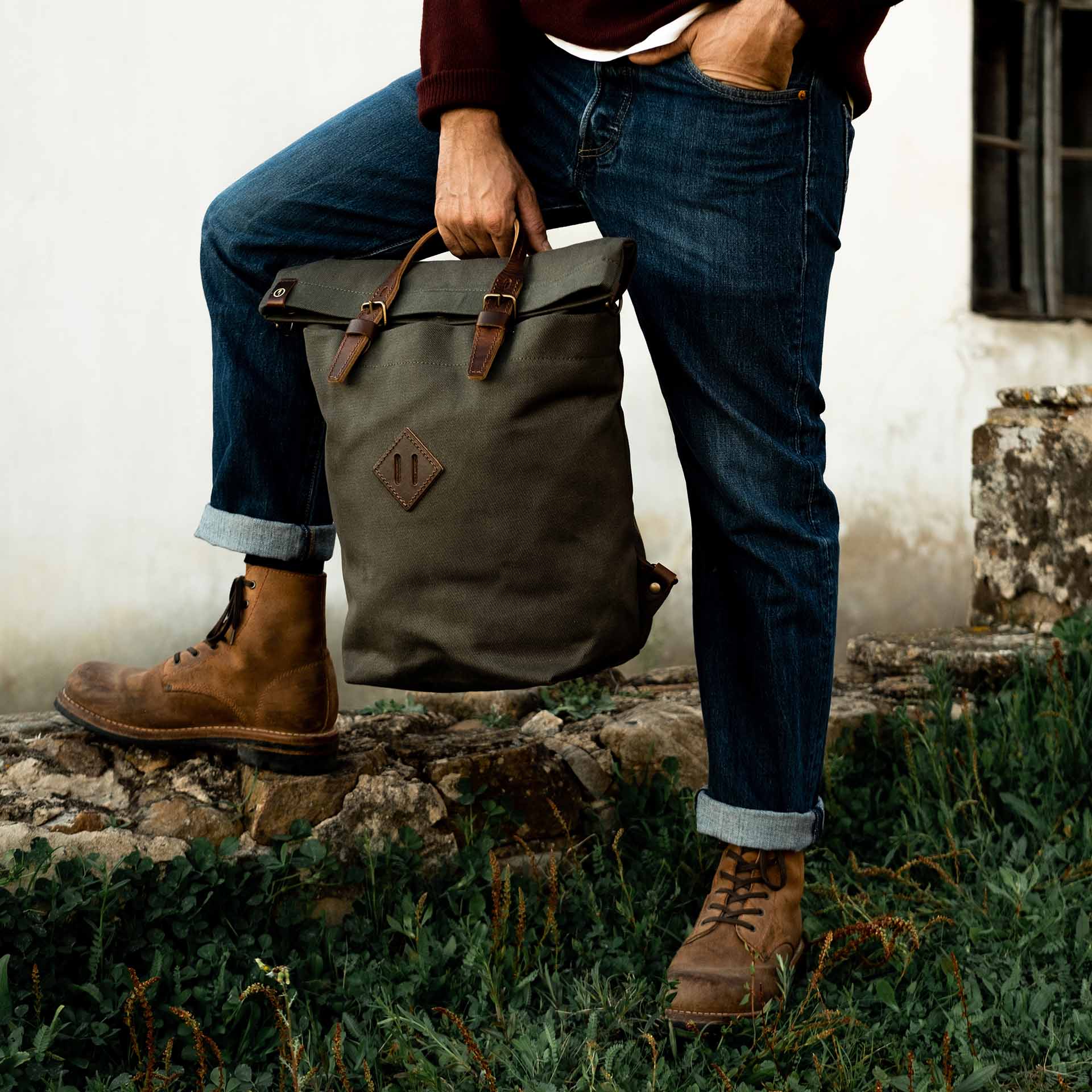 Woody canvas backpack carried by its handles