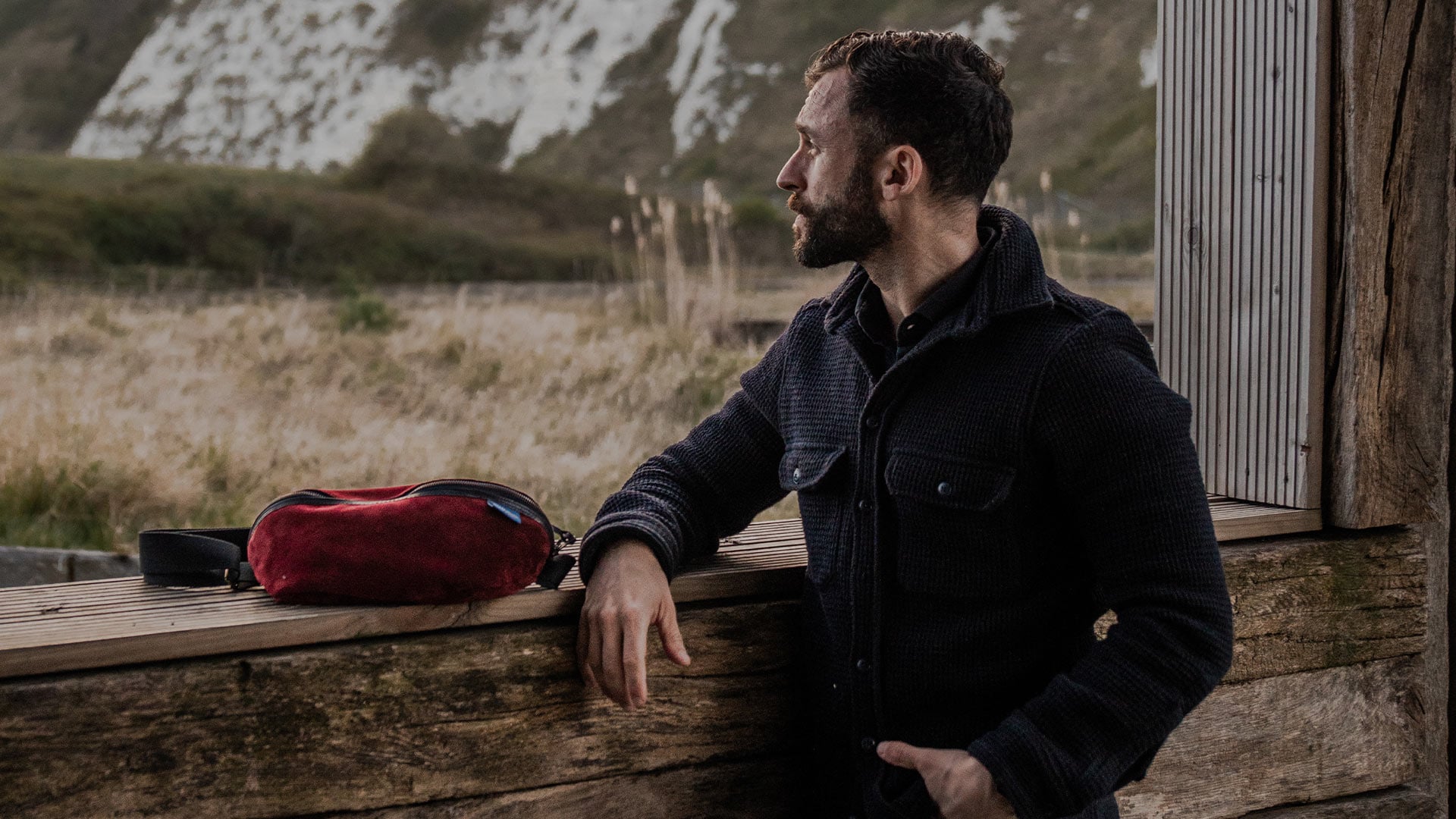 A man and a woman side by side carrying Bleu de Chauffe shopping bags
