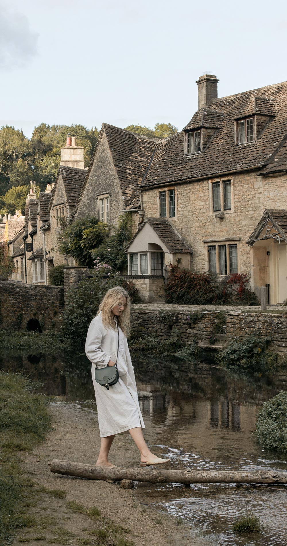 A woman carries her leather handbag in a country village