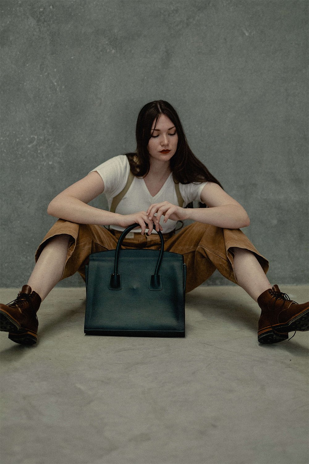 A woman sits in front of her Origami shopping bag