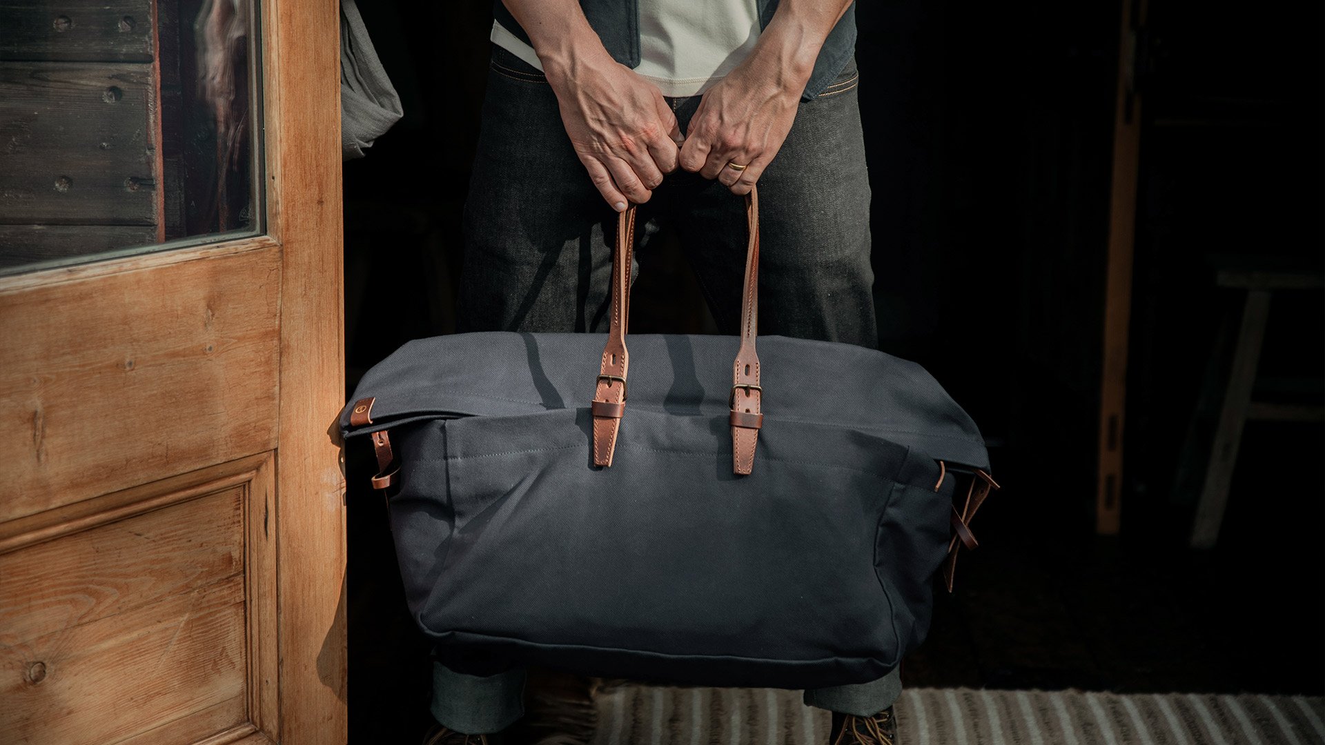 Men's canvas travel bag carried