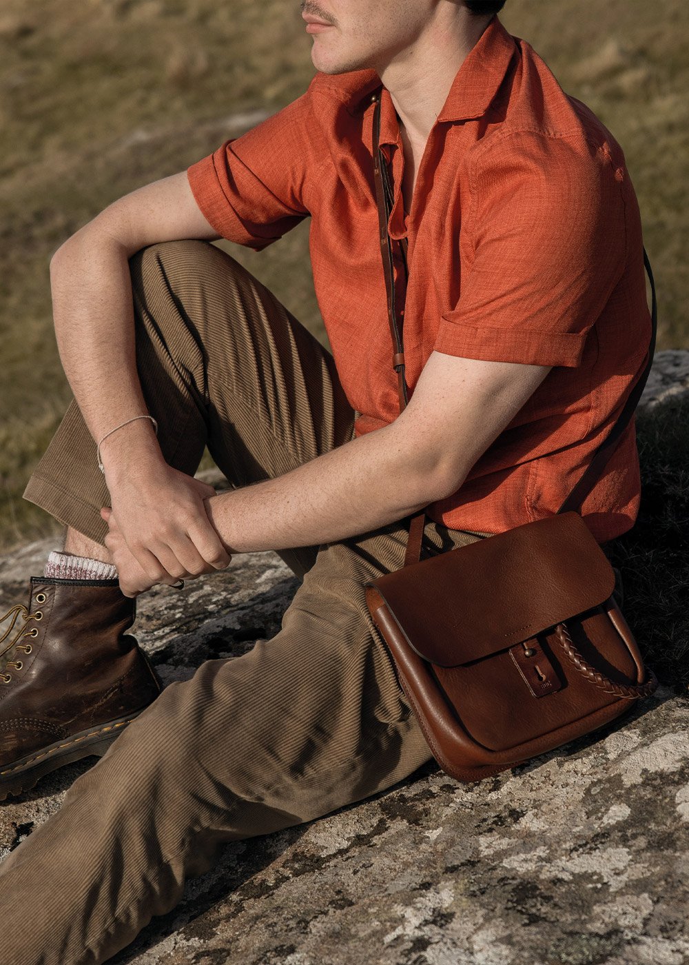 A young man poses with his cartridge pouch slung over his shoulder.