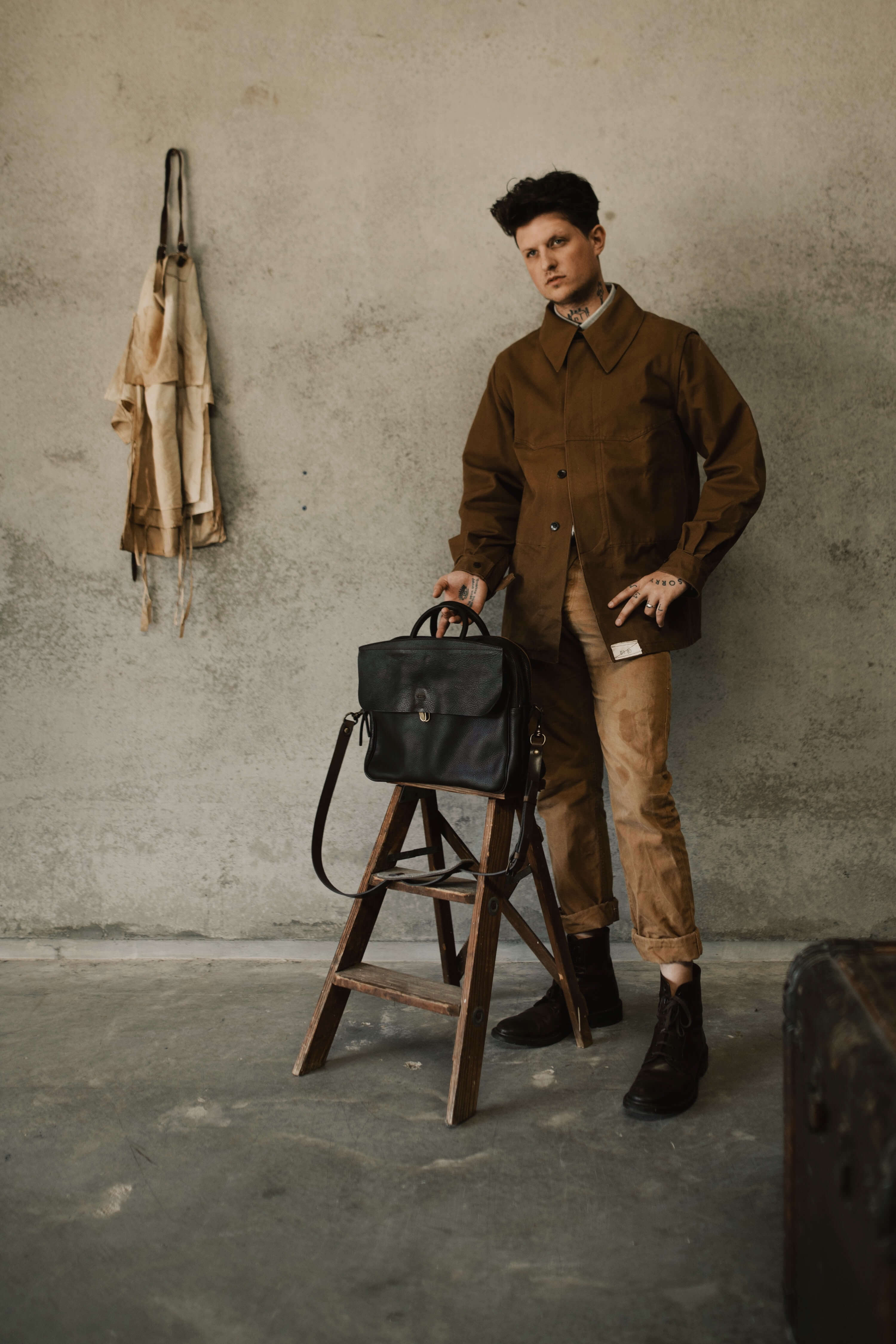 A man poses next to the Zeppo bag