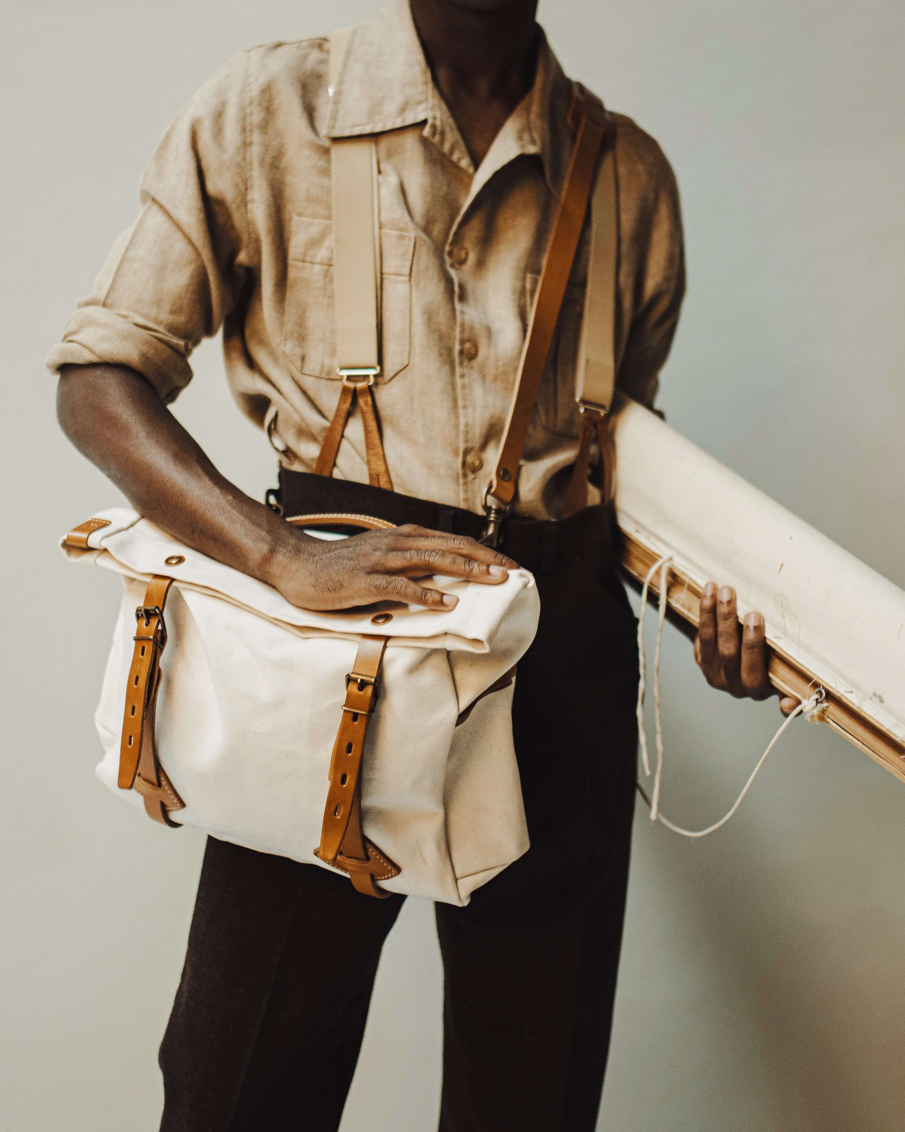 Un homme porte la musette Gaston en bandoulière